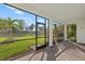 A screened patio with brick flooring offering scenic views of the lush, green backyard and landscaping at 11420 Golden Bay Pl, Bradenton, FL 34211