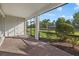 Covered patio with brick flooring, providing scenic views of a well-maintained yard and landscaping at 11420 Golden Bay Pl, Bradenton, FL 34211