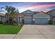 Charming single-story home features a three-car garage, well-maintained landscaping and decorative stone accents at 11421 Carlton Fields Dr, Riverview, FL 33579