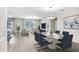 Open concept living room features a modern dining table and comfortable seating area at 11421 Carlton Fields Dr, Riverview, FL 33579