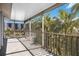 Screened balcony offering ample space and beautiful views of tropical foliage and nearby buildings at 1240 Dolphin Bay Way # 304, Siesta Key, FL 34242