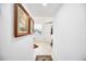Bright hallway with tile floor and decorative rugs leading to entry door and window at 1240 Dolphin Bay Way # 304, Siesta Key, FL 34242