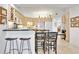 Open kitchen features ample cabinet space, breakfast bar and modern appliances at 1240 Dolphin Bay Way # 304, Siesta Key, FL 34242