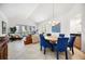 Bright living and dining area with tile flooring and sliding glass doors to a spacious balcony at 1240 Dolphin Bay Way # 304, Siesta Key, FL 34242