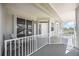 Welcoming porch with white railing, offering a view of the neighborhood and bright natural light at 1240 Dolphin Bay Way # 304, Siesta Key, FL 34242