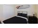 Simple bedroom with a full-size bed, a small nightstand, and an interior closet at 12616 Richezza Dr, Venice, FL 34293