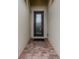 Elegant front door with decorative glass, set within a stone framed entryway and a paver walkway at 12616 Richezza Dr, Venice, FL 34293