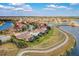 Beautiful aerial view showcasing homes with screened in lanais, sidewalks, lake and a scenic walking path at 13107 Bridgeport Xing, Lakewood Ranch, FL 34211