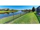 Well-maintained backyard with lush green grass and view of the lake at 13107 Bridgeport Xing, Lakewood Ranch, FL 34211