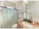 Bathroom featuring granite counters, wood cabinets and tiled shower at 13107 Bridgeport Xing, Lakewood Ranch, FL 34211