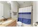 Bathroom featuring a granite vanity, shower with blue curtain, and a toilet at 13107 Bridgeport Xing, Lakewood Ranch, FL 34211