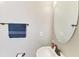 Bathroom with a round mirror, sink and towel hanging on the towel bar at 13107 Bridgeport Xing, Lakewood Ranch, FL 34211