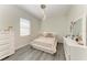 Bedroom featuring wood-look floors, accent lighting and all-white furniture at 13107 Bridgeport Xing, Lakewood Ranch, FL 34211