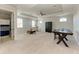 Expansive bedroom showcasing multiple windows, neutral carpet, and a decorative tray ceiling at 13107 Bridgeport Xing, Lakewood Ranch, FL 34211