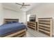 Bedroom with ceiling fan, wood-look floors and rustic furniture at 13107 Bridgeport Xing, Lakewood Ranch, FL 34211