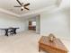Spacious bonus room featuring a wet bar, tray ceilings, neutral carpet and natural lighting at 13107 Bridgeport Xing, Lakewood Ranch, FL 34211