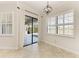 Dining area featuring tile floors, neutral walls, white trim and a sliding door to the lanai at 13107 Bridgeport Xing, Lakewood Ranch, FL 34211