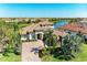Elegant home featuring a tile roof, paver driveway, lush landscaping and waterfront views in a vibrant community at 13107 Bridgeport Xing, Lakewood Ranch, FL 34211