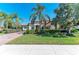 Inviting home featuring a manicured lawn, paver driveway, mature palms and stone accents for a luxurious feel at 13107 Bridgeport Xing, Lakewood Ranch, FL 34211