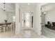 Bright foyer showcasing tile flooring, a decorative glass door, and views of the dining and living areas at 13107 Bridgeport Xing, Lakewood Ranch, FL 34211