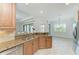 Open kitchen featuring a double sink, granite countertops and cabinetry overlooking a bright living area at 13107 Bridgeport Xing, Lakewood Ranch, FL 34211