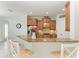 Kitchen counter with barstool seating, stainless steel appliances, granite countertops, and wooden cabinets at 13107 Bridgeport Xing, Lakewood Ranch, FL 34211