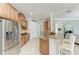 Spacious kitchen with granite countertops, stainless steel appliances, wooden cabinets, and barstool seating at the counter at 13107 Bridgeport Xing, Lakewood Ranch, FL 34211