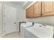 Laundry room features a sink, cabinets, tile floors, washer, and dryer at 13107 Bridgeport Xing, Lakewood Ranch, FL 34211