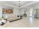 Open-concept living area with neutral furniture, pendant lighting, and seamless flow to the dining and kitchen areas at 13107 Bridgeport Xing, Lakewood Ranch, FL 34211