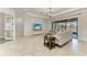Spacious living room featuring tile floors, a large sliding glass door, and neutral decor for comfortable living at 13107 Bridgeport Xing, Lakewood Ranch, FL 34211