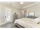 Spacious main bedroom featuring wood-look floors, neutral walls and access to the lanai at 13107 Bridgeport Xing, Lakewood Ranch, FL 34211