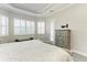 Main bedroom featuring wood-look floors, neutral walls and trim, with windows and access to the lanai at 13107 Bridgeport Xing, Lakewood Ranch, FL 34211