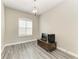 Office area with wood-look floors, built-in desk and large window at 13107 Bridgeport Xing, Lakewood Ranch, FL 34211