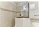 Shower featuring decorative tile border and glass enclosure at 13107 Bridgeport Xing, Lakewood Ranch, FL 34211