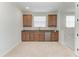 A clean wet bar features shaker style cabinets and a stainless steel refrigerator at 13107 Bridgeport Xing, Lakewood Ranch, FL 34211
