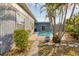 View of the backyard features a nice outdoor pool, plants, and a partial view of the home at 1320 Magellan Dr, Sarasota, FL 34243