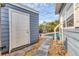 Backyard shows a partial pool view, the home, some rock landscaping and a sidewalk at 1320 Magellan Dr, Sarasota, FL 34243