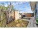 Backyard view shows a storage shed, wooden fence, grass and some patio stones at 1320 Magellan Dr, Sarasota, FL 34243
