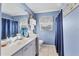 Light and bright blue bathroom features a tub and shower with a window that lets in natural light at 1320 Magellan Dr, Sarasota, FL 34243