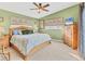 Spacious bedroom with green walls, a ceiling fan, and ample natural light at 1320 Magellan Dr, Sarasota, FL 34243