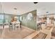 Cozy dining room with green accent wall adjacent to a functional kitchen and living space at 1320 Magellan Dr, Sarasota, FL 34243