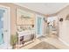 Foyer featuring neutral colors, a beach themed painting and decor, and wood look floors at 1320 Magellan Dr, Sarasota, FL 34243