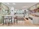 Bright kitchen featuring a bar counter, white cabinets, wood look floors, and a window over the sink at 1320 Magellan Dr, Sarasota, FL 34243