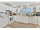 Bright kitchen featuring white cabinets, countertops, and modern appliances for a clean, contemporary look at 1320 Magellan Dr, Sarasota, FL 34243