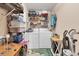 Well-organized laundry room with washer, dryer, shelving, and laundry essentials for efficient chores at 1320 Magellan Dr, Sarasota, FL 34243