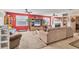 Spacious living room with bright red accent wall, media center, and comfortable seating at 1320 Magellan Dr, Sarasota, FL 34243