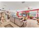 Open concept living room with carpet, comfortable sofas, and large windows at 1320 Magellan Dr, Sarasota, FL 34243