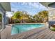 This pool has an outdoor brick patio. Some palm trees are around the fenced-in pool at 1320 Magellan Dr, Sarasota, FL 34243