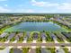 Stunning aerial view of lakeside homes surrounded by lush greenery and blue skies at 13487 Old Creek Ct, Parrish, FL 34219