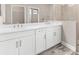 Well-lit bathroom features dual sinks with ample counter space and bright, white cabinets at 13487 Old Creek Ct, Parrish, FL 34219